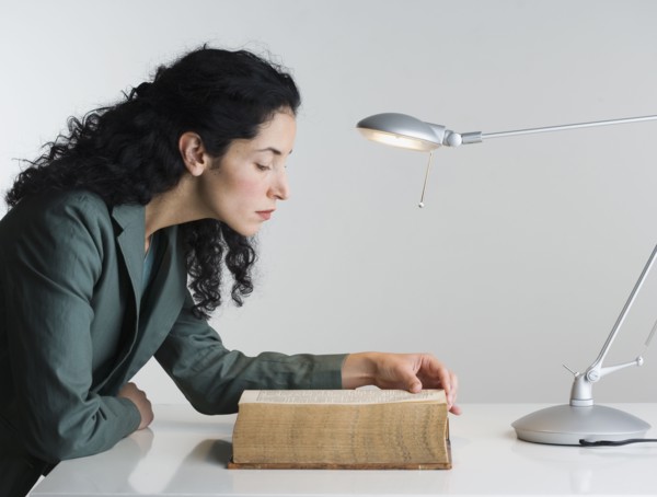 Woman reading thick book