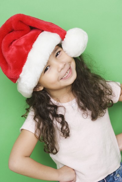 Portrait of girl smiling while wearing Santa hat