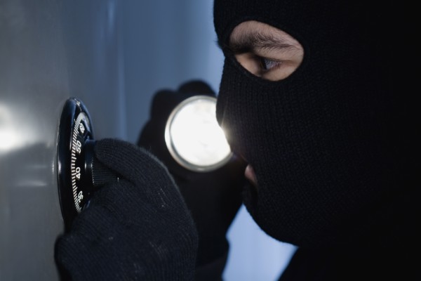 Thief unlocking a combination lock