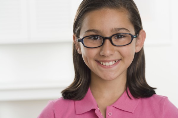 Hispanic girl wearing eyeglasses and smiling