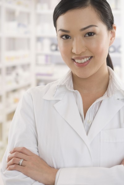 Asian female pharmacist standing in pharmacy