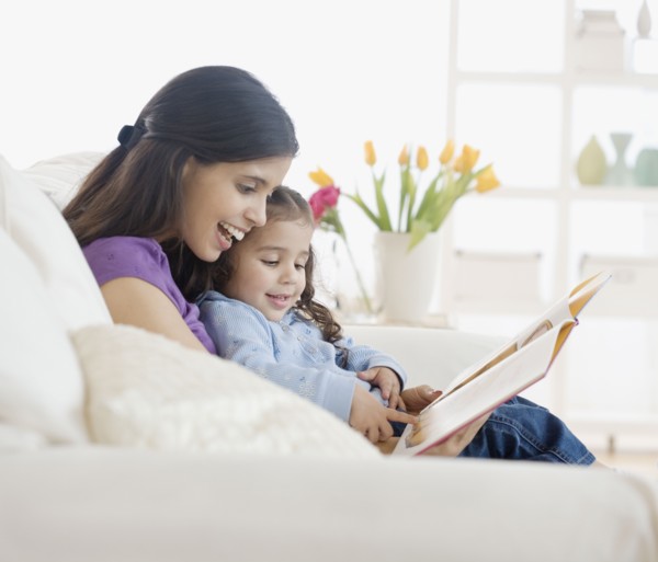 Hispanic mother reading to daughter
