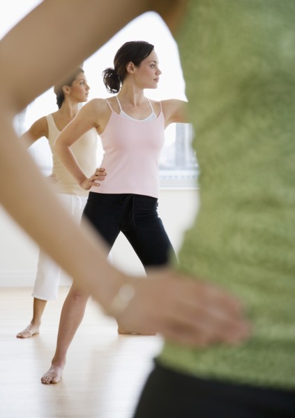 Three young women in yoga class