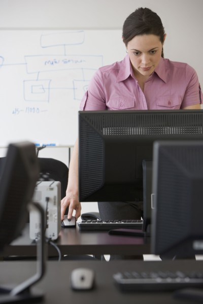Hispanic businesswoman looking at computer