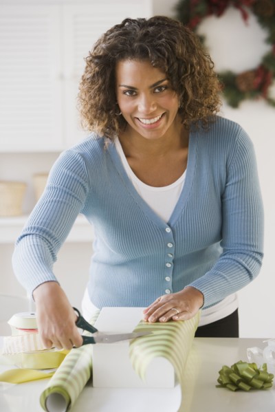 African woman wrapping gift