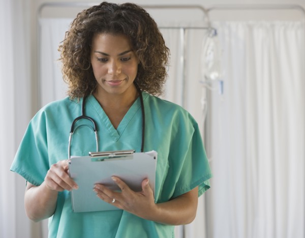 African female doctor looking at chart