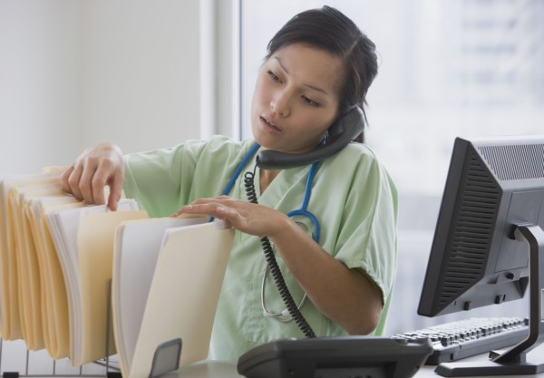 Asian female doctor talking on telephone