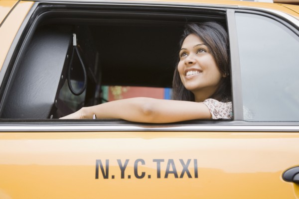 Mixed Race woman looking out taxi cab window