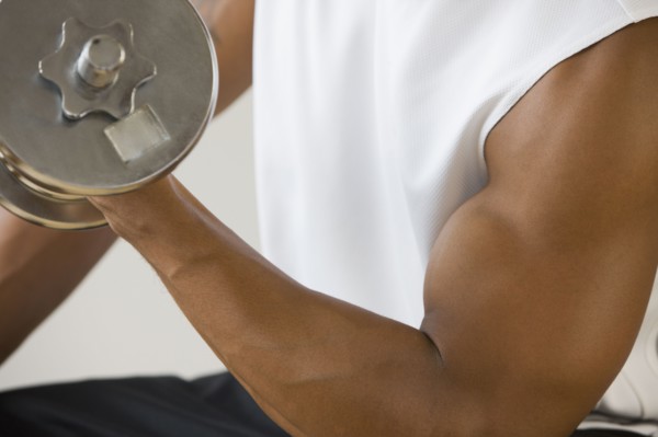 African man lifting dumbbell