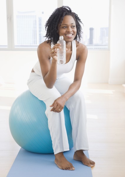African woman sitting on exercise ball