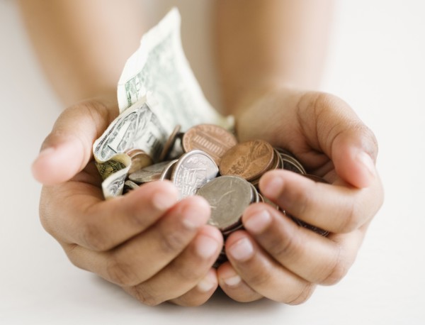 Close up of mixed race girl holding money