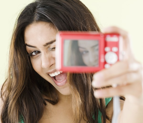 Middle Eastern woman taking self-portrait