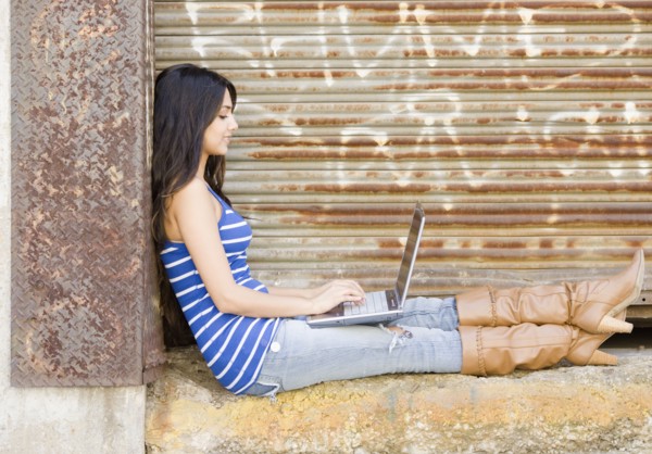 Middle Eastern woman typing on laptop