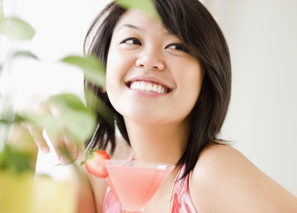 Asian woman drinking pink martini