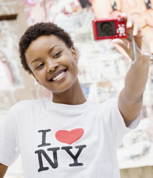 African woman taking self-portrait with digital camera