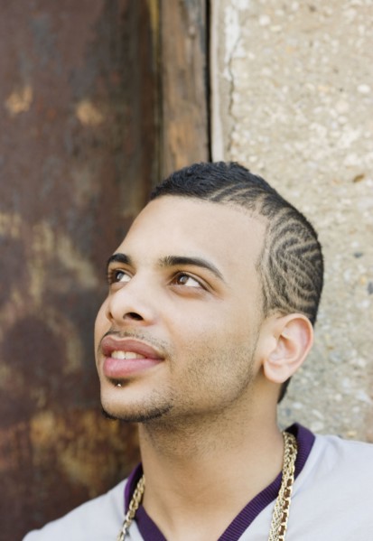 Hispanic teenage boy with design shaved into his head