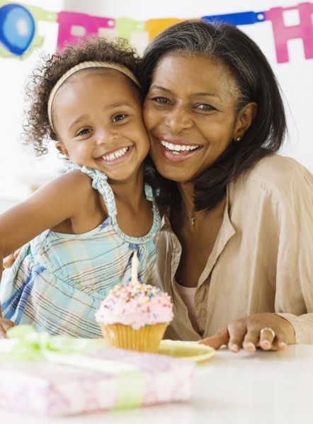 African grandmother hugging granddaughter on her birthday