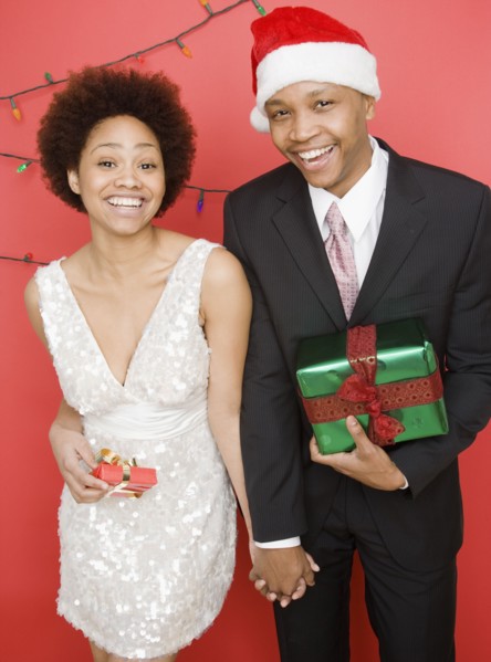 African couple holding Christmas presents