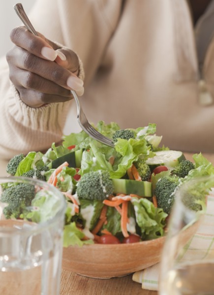 African woman eating healthy salad