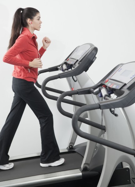 Hispanic woman walking on treadmill