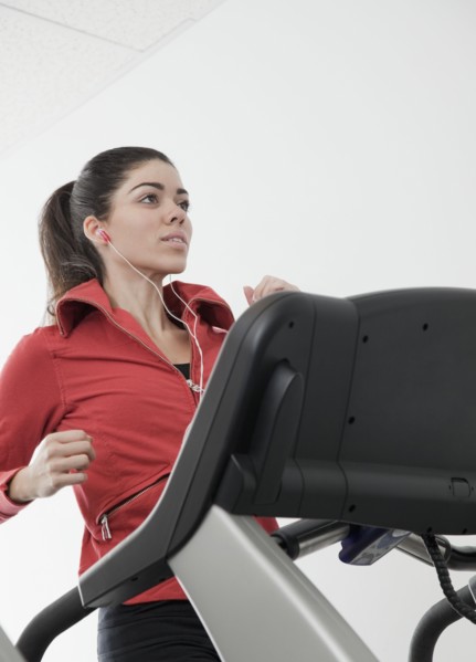 Hispanic woman walking on treadmill