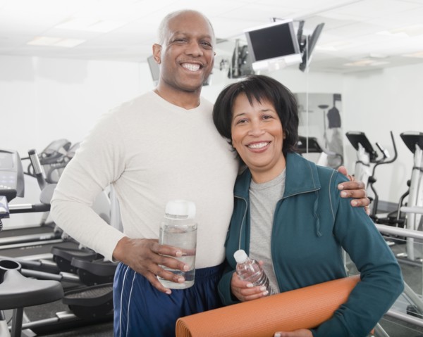 African couple standing in health club