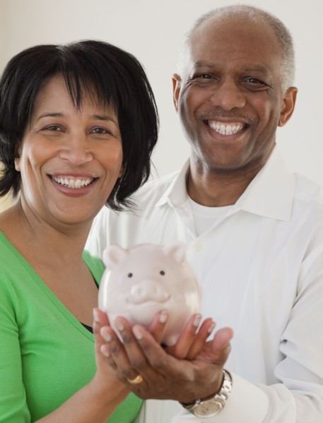 African couple holding piggy bank