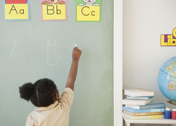 African girl writing on blackboard