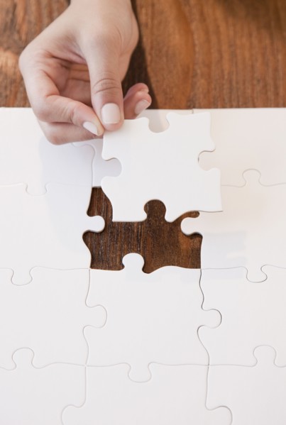 Woman completing jigsaw puzzle