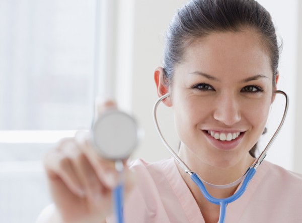 Mixed race nurse holding stethoscope