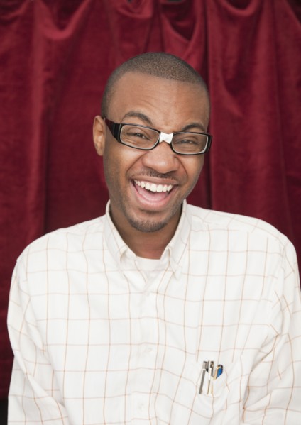 African man wearing taped eyeglasses and making a face
