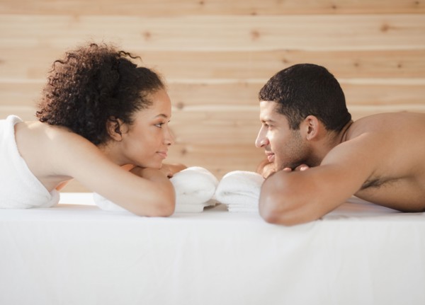 Couple laying face to face on massage table