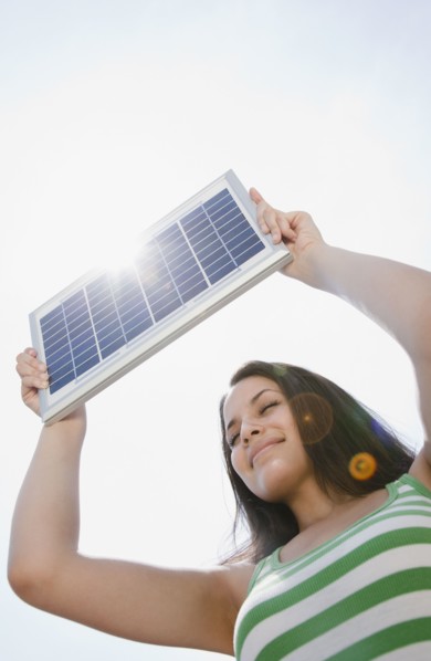 Mixed race woman holding solar panel