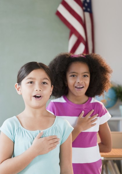 School girls pledging allegiance to the flag