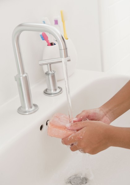 Hispanic girl washing hands