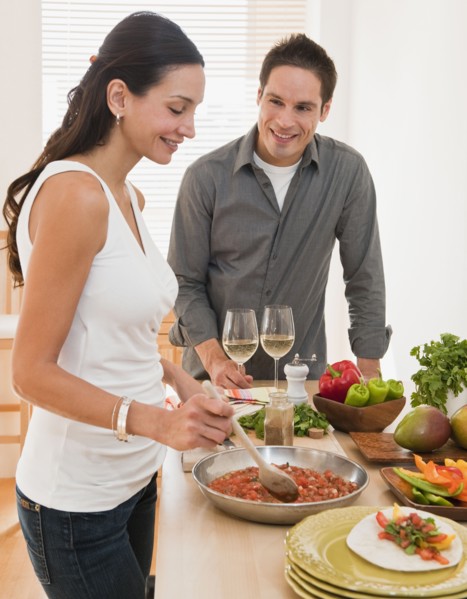 Hispanic couple cooking dinner