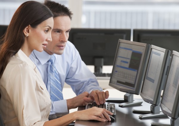 Hispanic business people working on computer
