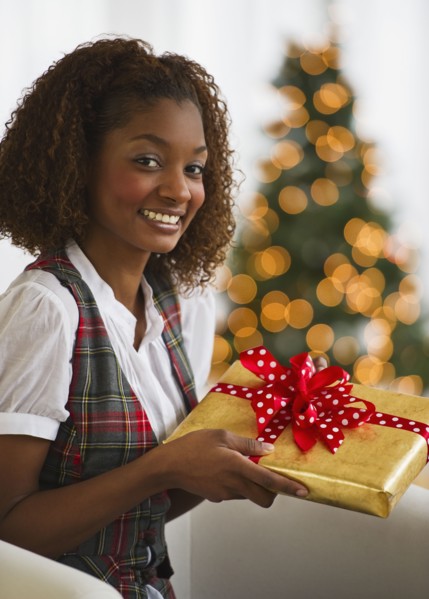 Mixed race woman holding Christmas gift