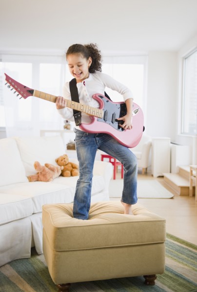 Hispanic girl playing guitar