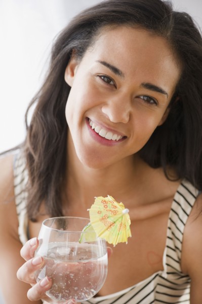 Mixed race woman drinking cocktail