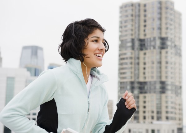 Hispanic woman running in city