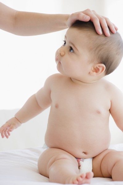 Mother comforting mixed race baby boy