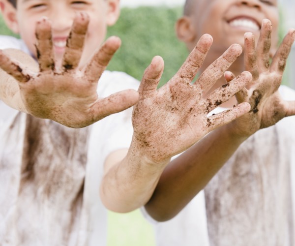 Boys displaying their messy hands