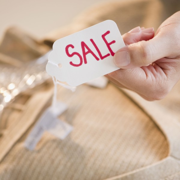 Hand holding clothing sale tag