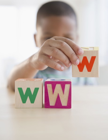 African American boy spelling WWW with blocks