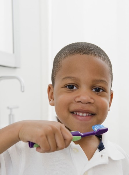 African American boy brushing teeth