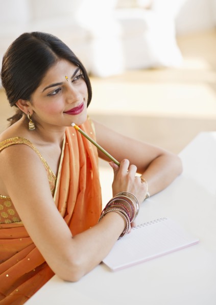 Indian woman in traditional Indian clothing thinking