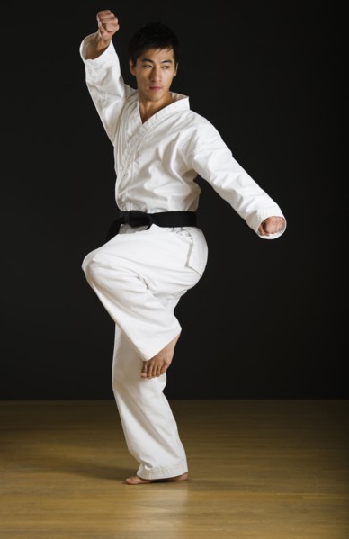 Asian male black belt practicing karate