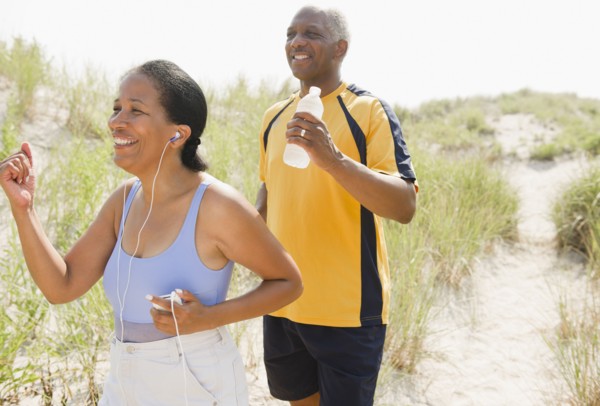 Black couple exercising on beach
