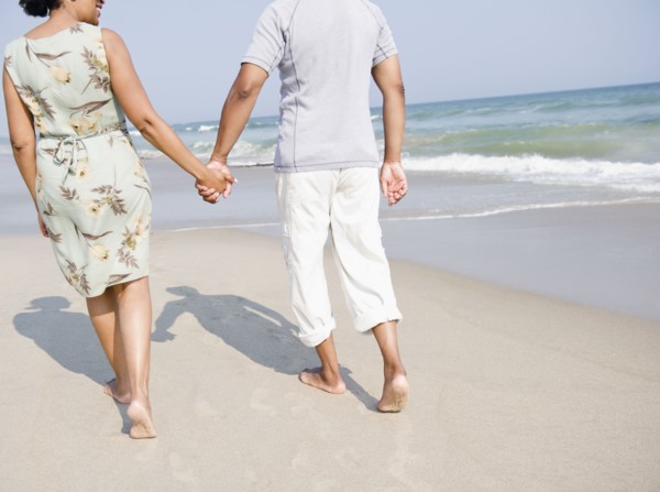 Black couple enjoying beach together